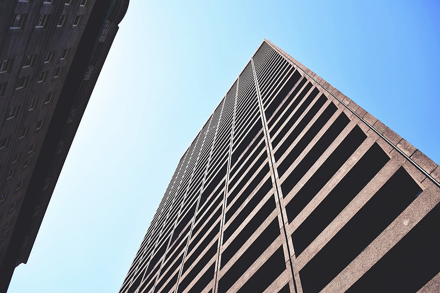 Low angle view of modern skyscraper against blue sky