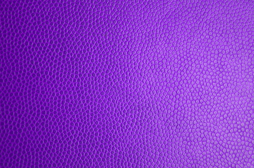 Purple textured surface background with pebbled pattern