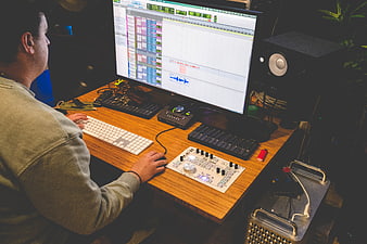 Music Producer Working at Recording Studio Desk
