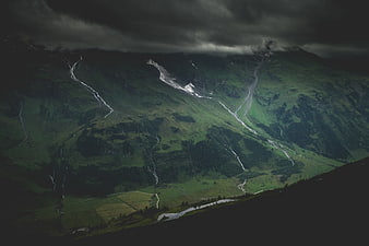Dramatic aerial view of green mountain valley with streams