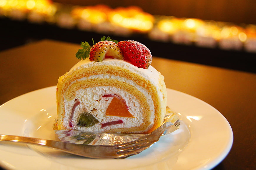 Strawberry Swiss Roll Cake Slice on White Plate
