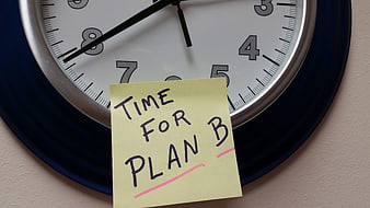 Yellow sticky note reading Time For Plan B on a wall clock