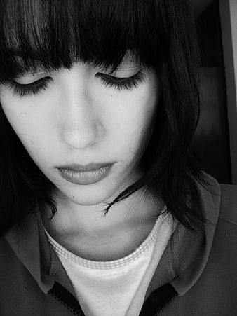 Close-up portrait of a woman with eyes closed in black and white