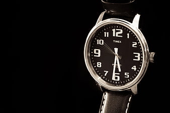 Close-up of Silver Timex Watch with Black Leather Strap