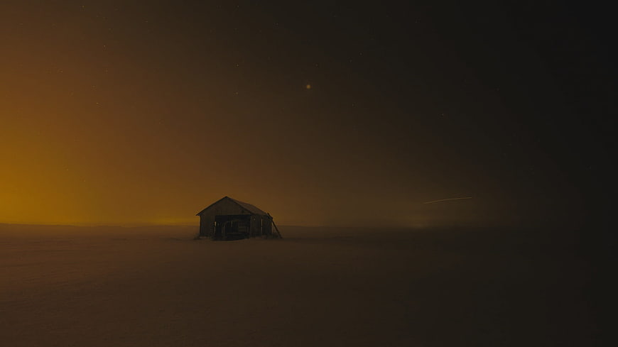 Lonely Cabin in Snowy Landscape Under Starry Night Sky