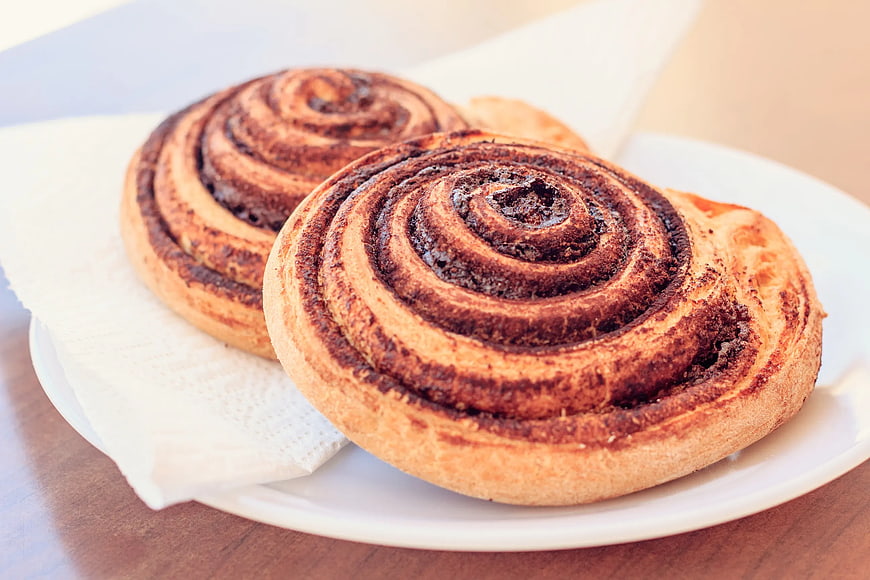 Two Fresh Cinnamon Rolls on White Plate