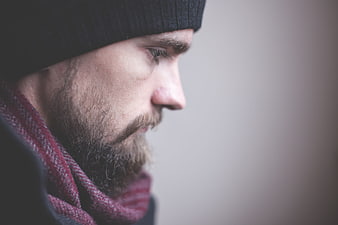 Profile Portrait of Bearded Man in Winter Scarf and Beanie