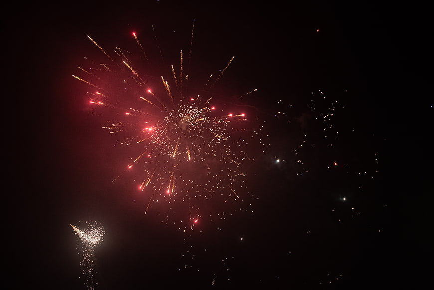 Red and Gold Fireworks Exploding in Night Sky