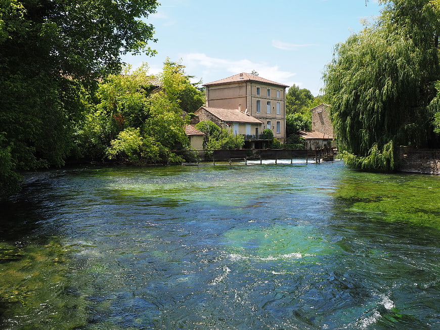 Clear River Flowing Past Historic Stone Mill House