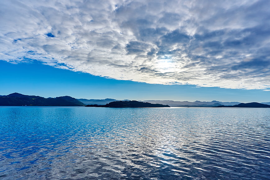 Serene Lake Landscape with Blue Sky and Clouds