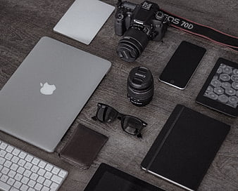 Flat lay of photographer workspace with camera, laptop, and accessories