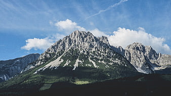Majestic Alpine Mountain Peak with Blue Sky and Clouds