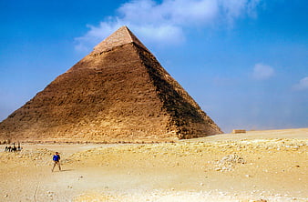 Tourist posing in front of the Great Pyramid of Giza in Egypt