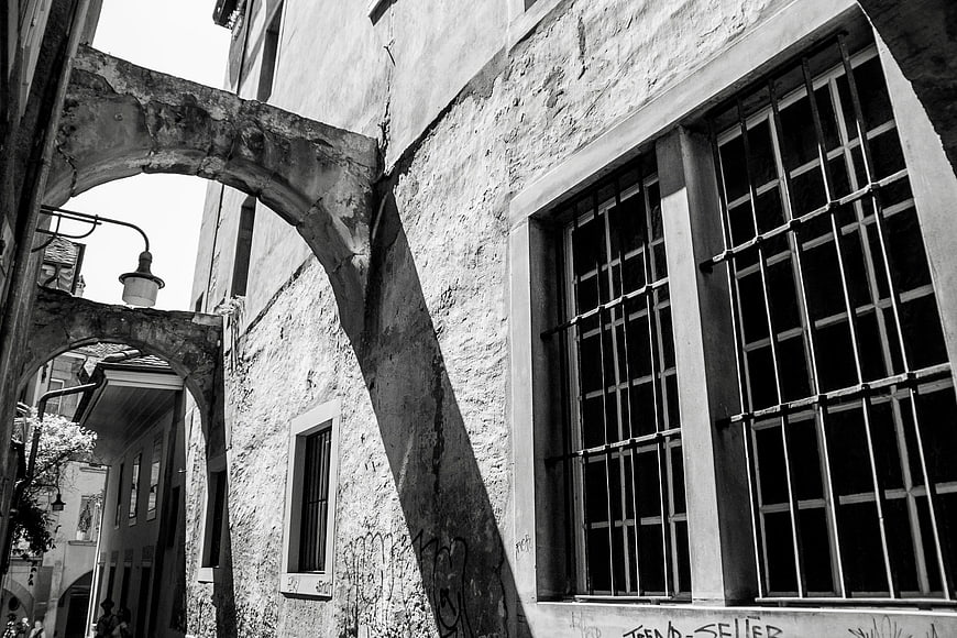 Black and White Photo of Old Stone Archway and Barred Windows