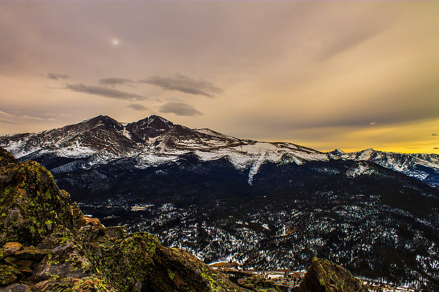 Snowy Mountain Peaks at Sunset with Golden Sky