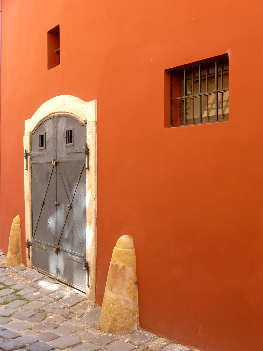 Vibrant Orange Wall with Iron Gate in Szentendre