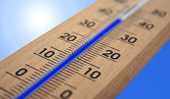 Wooden Thermometer Close-Up Against Blue Sky