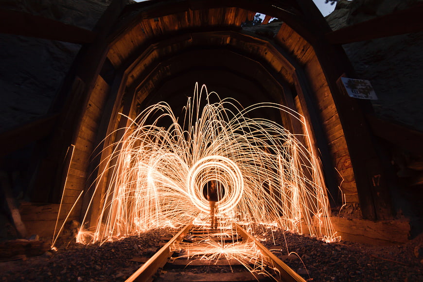 Steel wool sparks light painting in wooden tunnel