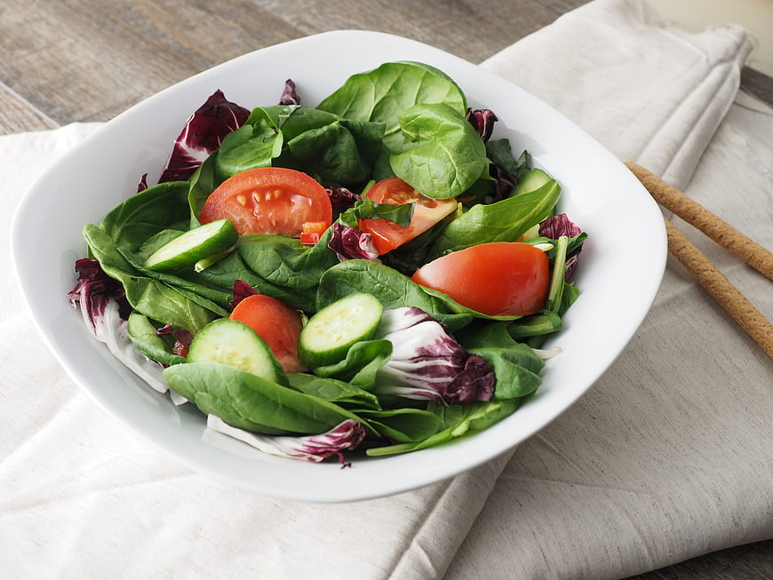 Fresh Green Salad with Tomatoes and Cucumbers in White Bowl