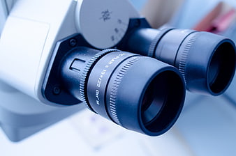 Close-up of microscope eyepieces in a laboratory setting