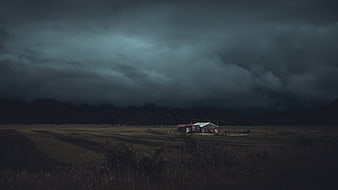 Dark Stormy Sky Over Rural Farmhouse Landscape