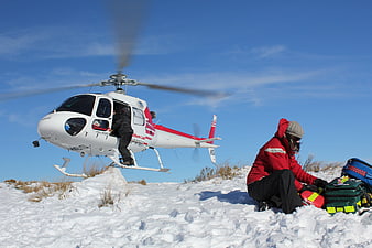 Helicopter Medical Rescue Team Preparing Equipment In Snowy Terrain