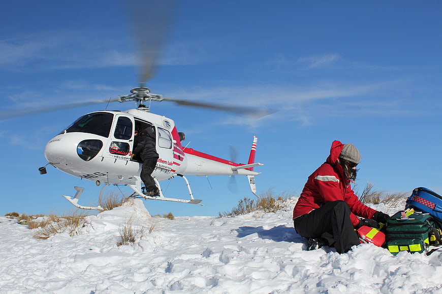 Helicopter Medical Rescue Team Preparing Equipment In Snowy Terrain
