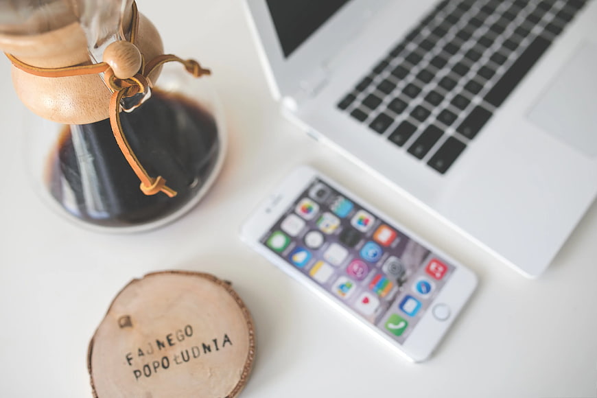 Top View of Chemex Coffee, Laptop, and Smartphone on White Desk