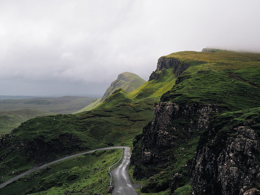 Winding Road Through Green Highland Mountains