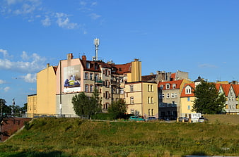 Colorful European Cityscape with Yellow Buildings and Blue Sky