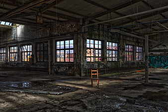 Abandoned Industrial Factory Interior With Graffiti And Single Chair