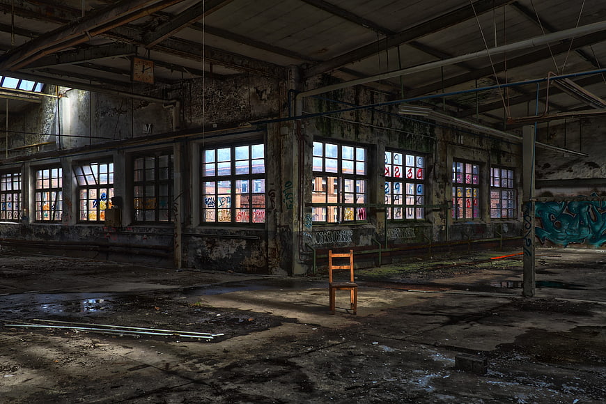 Abandoned Industrial Factory Interior With Graffiti And Single Chair