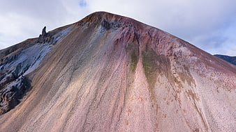 Colorful volcanic mountain slope with mineral streaks