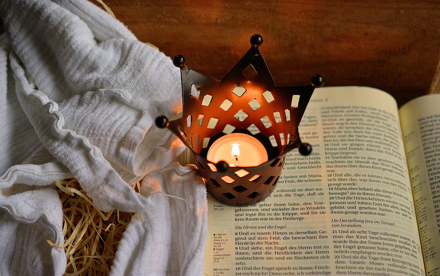Advent Crown Candle on Open Bible with Straw and Cloth