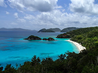Aerial View of Tropical Beach with Turquoise Water and Lush Hills