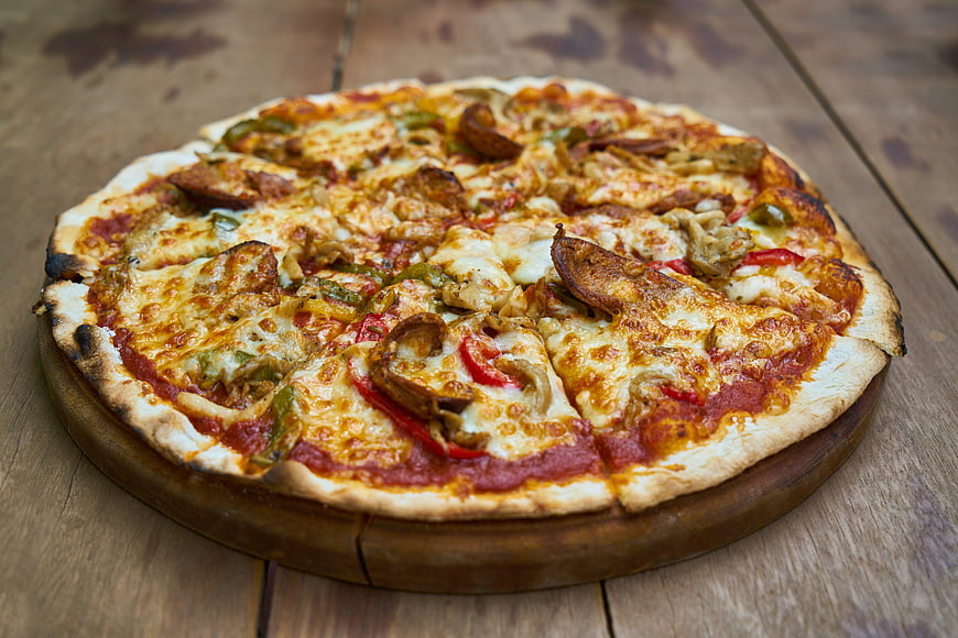 Delicious Pepperoni and Vegetable Pizza on Wooden Board