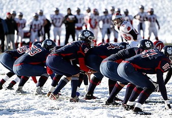 American Football Team Lining Up on Snowy Field