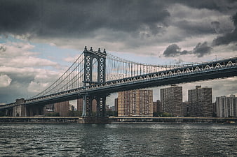 Manhattan Bridge New York City Skyline Under Dramatic Clouds