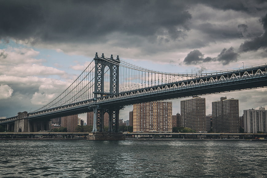 Manhattan Bridge New York City Skyline Under Dramatic Clouds