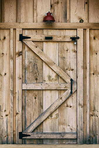 Rustic Wooden Barn Door with Red Industrial Lamp
