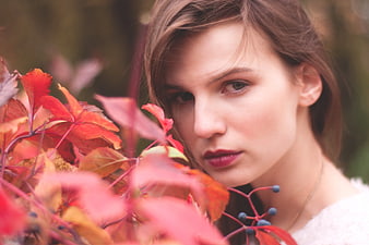 Portrait of Woman with Red Autumn Leaves