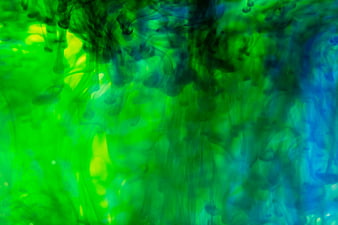 Abstract Green and Blue Ink Swirling in Water