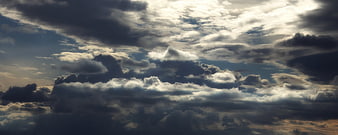 Dramatic dark storm clouds with bright sunlight breaking through