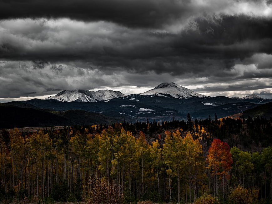 Dramatic Autumn Mountain Landscape with Snow-Capped Peaks