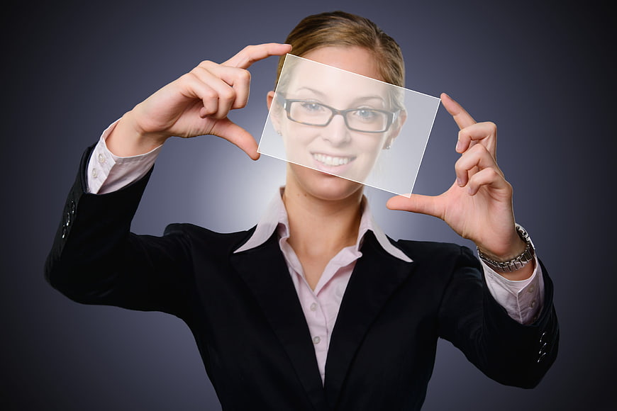 Businesswoman holding transparent screen mockup