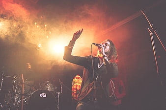 Male Rock Singer Performing on Stage with Dramatic Lighting