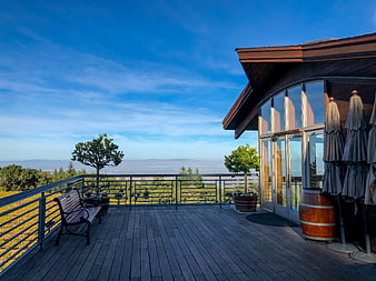 Modern wooden deck with panoramic valley view and blue sky
