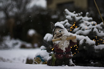 Snowy Garden Gnome with Christmas Lights in Winter