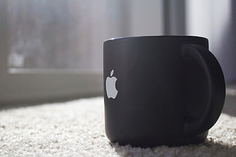 Black Coffee Mug with Apple Logo on Carpet