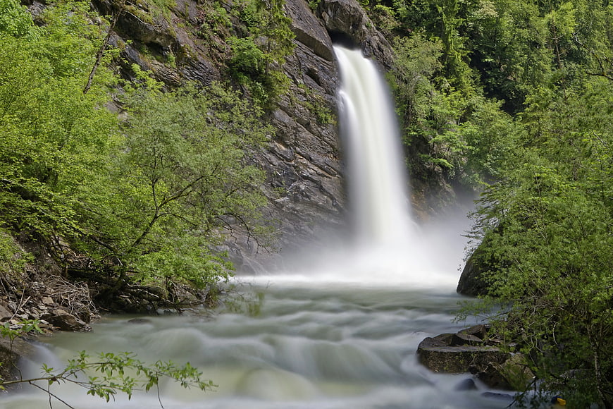 Majestic Waterfall Cascading Through Lush Green Forest